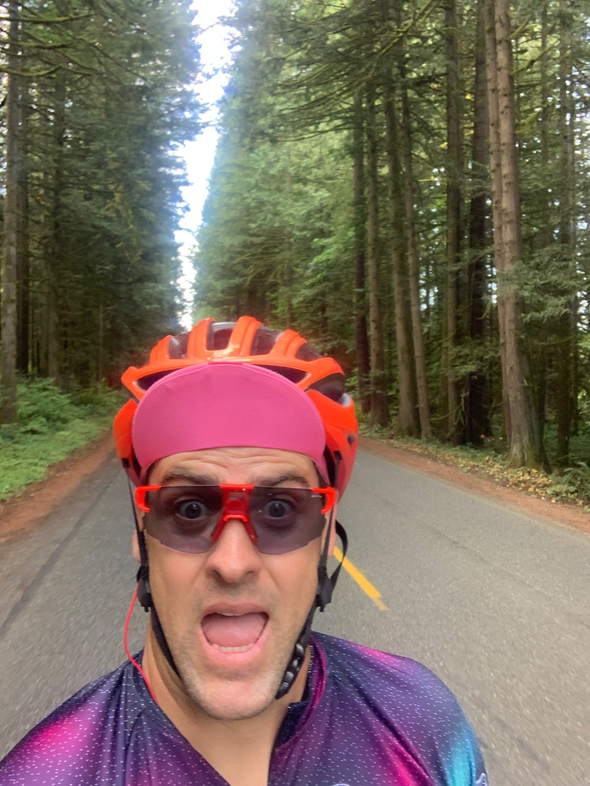 Rob takes a selfie with tree-lined road behind him.