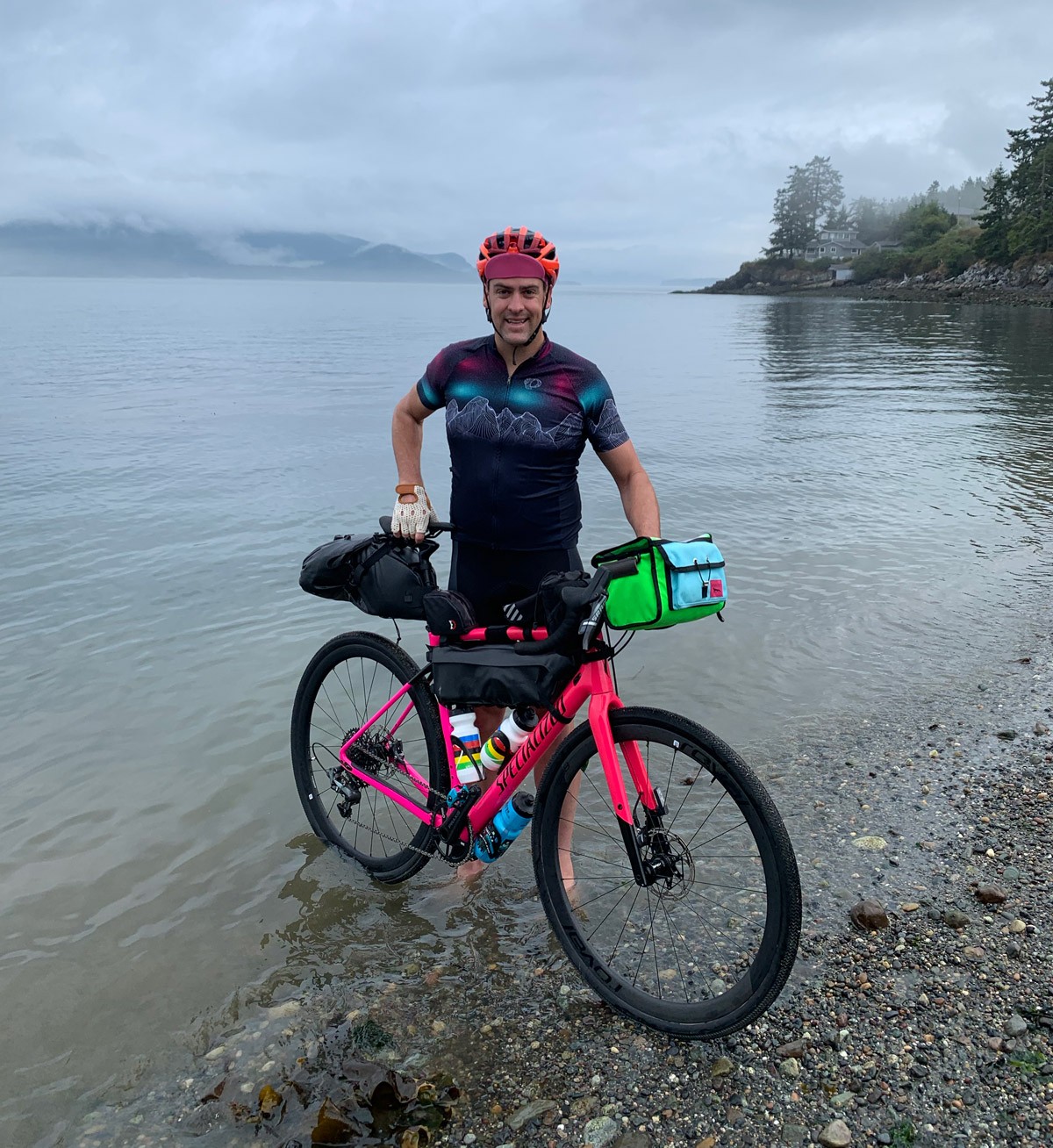 Rob Lea standing with bike in Pacific Ocean prior to starting Ride Across America.