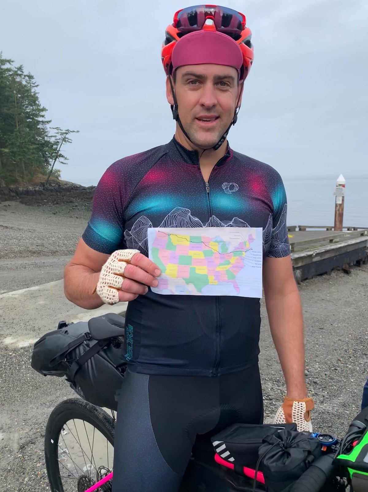 Rob Lea holding map of projected route for Ride Across America.